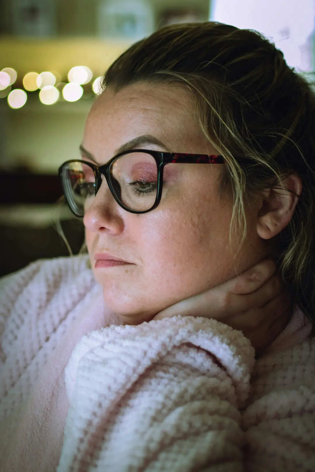 woman in white knit sweater wearing black framed eyeglasses