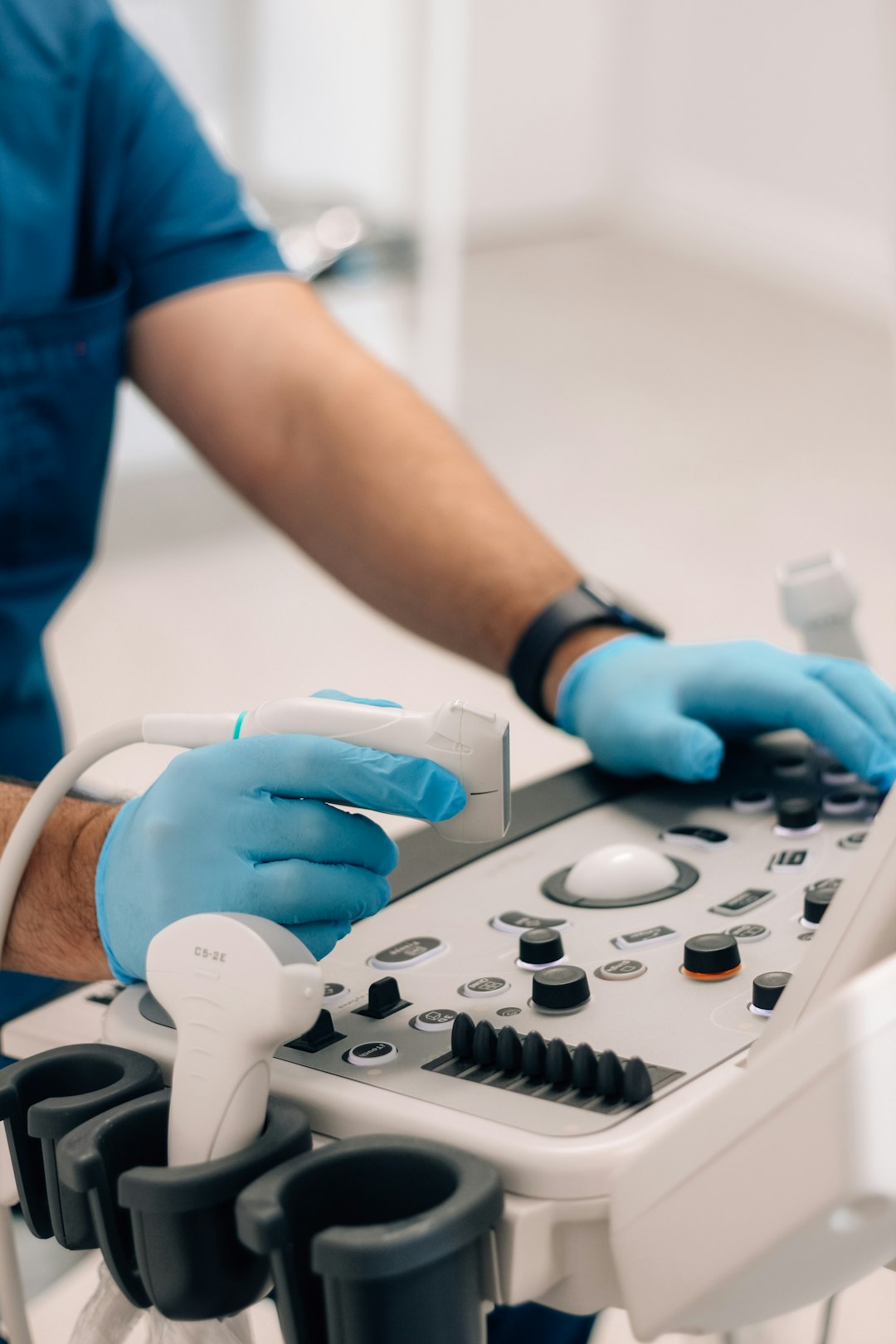 Photo by Elen Sher a person in blue gloves operating a machine